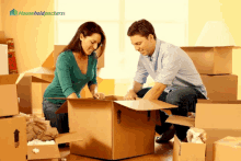 a man and a woman are opening a cardboard box with householdpackers written in the corner