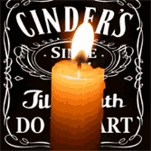 a candle is lit up in front of a sign that says cinder 's