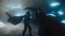 a man in a cape is being punched by another man in a cape