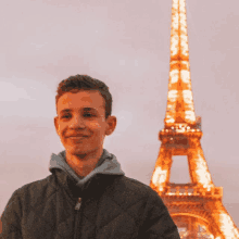 a young man in front of the eiffel tower