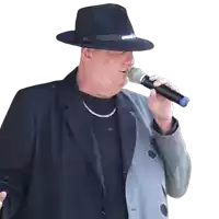 a man singing into a microphone with a black hat that says army on it