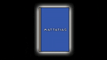 a person is holding a blue book that says #mattatao on it