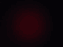 a black background with a red gradient in the middle of it