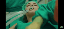 a woman is laying in an operating room with an oxygen mask on her face