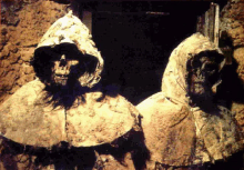 two skeletons are standing next to each other in a dark room .