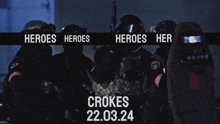 a group of soldiers are standing in front of a sign that says heroes heroes her crokes 22.03.24