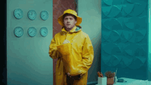 a man wearing a yellow raincoat and a yellow hat