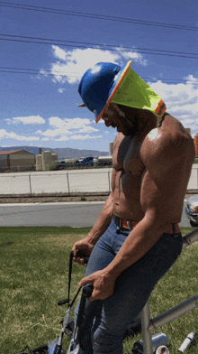 a shirtless construction worker wearing a hard hat and safety vest