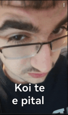 a close up of a man 's face with glasses and the words koi te e pital below him