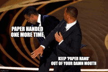 two men in suits are fighting with the caption " paper handed one more time "