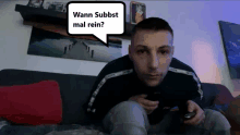 a man is sitting on a couch with a speech bubble that says wann subbst mal rein