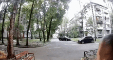 a black car is parked on the side of the road in front of a building