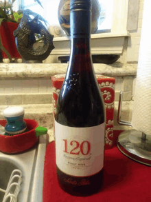 a bottle of 120 reserva especial pinot noir sits on a kitchen counter