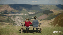 a poster for the end of the f *** ing world shows a man and woman sitting on a bench