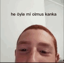 a close up of a man 's face with the words he öyle mi olmus kanka written on the bottom