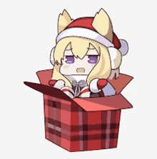 a little girl wearing a santa hat is sitting in a red box