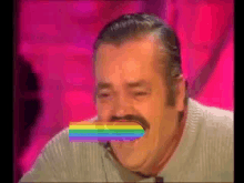 a man with a mustache is laughing with a rainbow sticker on his mouth .