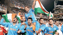 a group of men wearing india jerseys are holding up flags