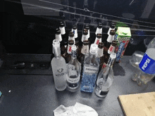 a bunch of bottles of liquor are sitting on a counter .