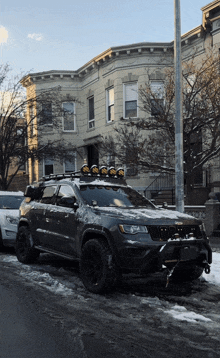 a jeep is parked on the side of a snowy street