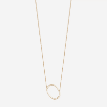 a gold necklace with a large oval pendant