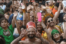 a crowd of people with their arms in the air at a festival