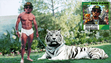 a man standing next to a white tiger with a zoo pass