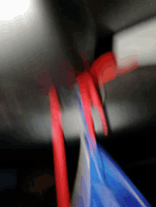 a blurry picture of a red and blue object with a black background