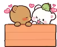 a teddy bear and a white bear are sitting on a wooden box .