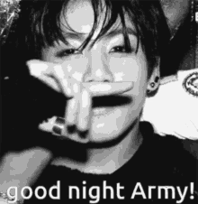 a black and white photo of a young man covering his face with his hands and the words `` good night army '' .