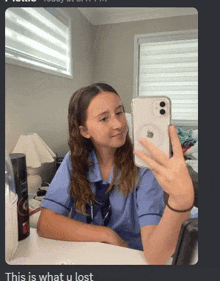 a girl is taking a picture of herself in the mirror