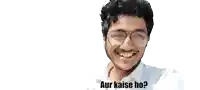 a young man wearing glasses and a white shirt is smiling with the words " aur kaise ho " below him