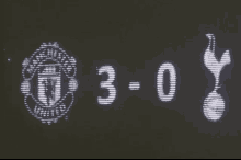 a scoreboard showing manchester united and tottenham hotspur 's scores