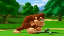 donkey kong is playing golf on a green field and hitting a golf ball with a golf club .