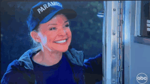 a woman wearing a blue hat that says paramedic is smiling