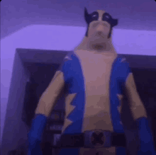 a person in a wolverine costume is standing in front of a wall .