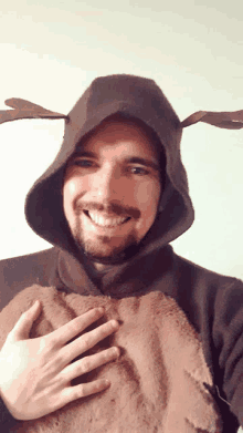 a man wearing a reindeer costume with antlers