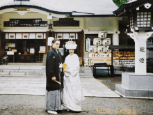 a bride and groom pose in front of a building with a sign that says ' a ' on it