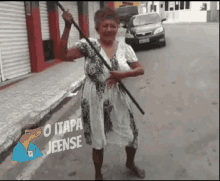 a woman in a white dress is holding a stick with the words " o itapa jeense " written on the bottom