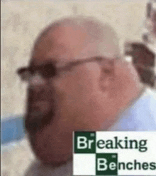 a bald man with glasses and a beard is wearing breaking benches .