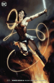 wonder woman is holding a sword on the cover of a comic book