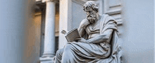 a statue of a man with a beard is sitting in front of a building reading a book .