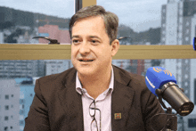 a man sitting in front of a shure microphone that says brasil