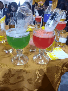 a bottle of corona is being poured into a green and red drink