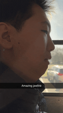 a man with an amazing jawline looks out the window