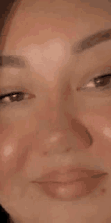 a close up of a woman 's face with a slight smile on it .