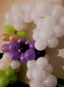 a bunch of balloons including purple white and black