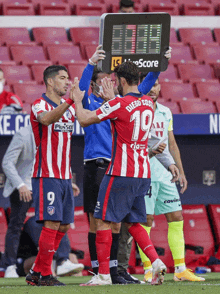 a soccer player wearing a red and white striped jersey with the number 19 on it