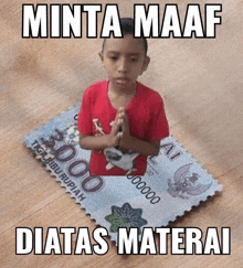 a young boy in a red shirt is praying on a postage stamp that says 3000 rupiah .