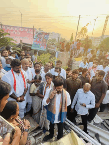 a crowd of people gathered in front of a billboard that says ' congress ' on it